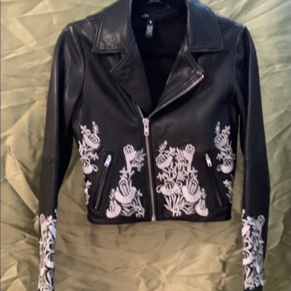 Aqua leather jacket, with white embroidery.